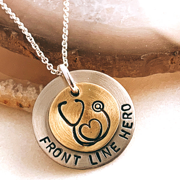 front line hero necklace on rock