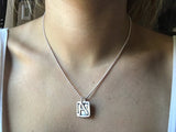 girl wearing letter A necklace